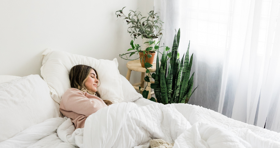 Woman sleeping in a room with a closed window, increasing CO2 levels